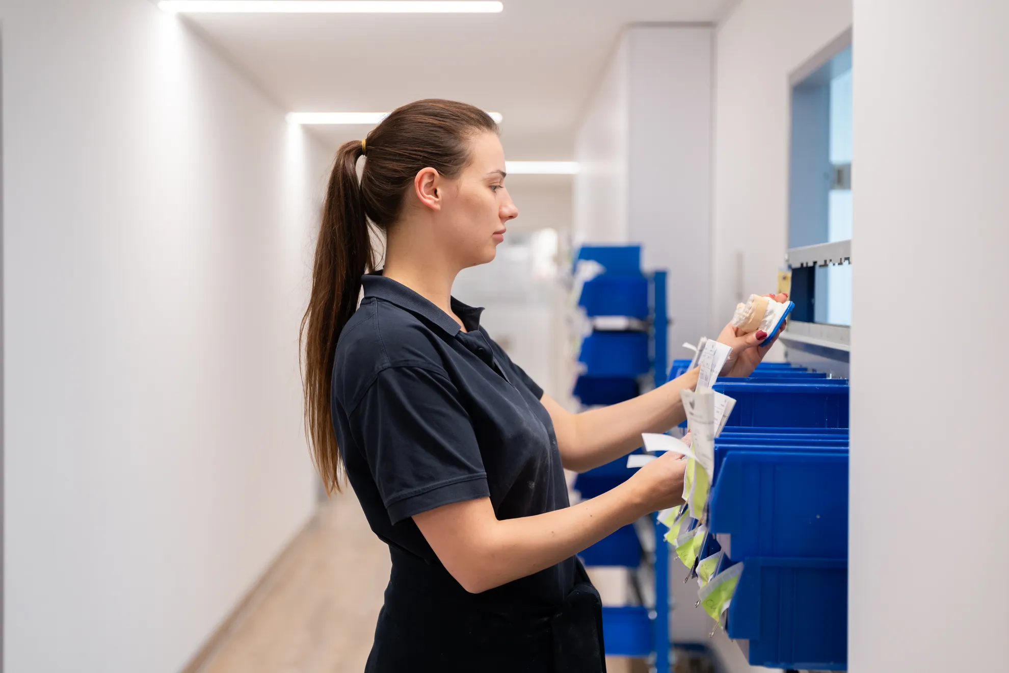 Mitarbeiterin schaut sich ein Gebiss an